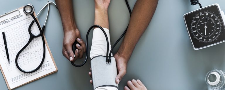 Nurse measuring patient blood pressure